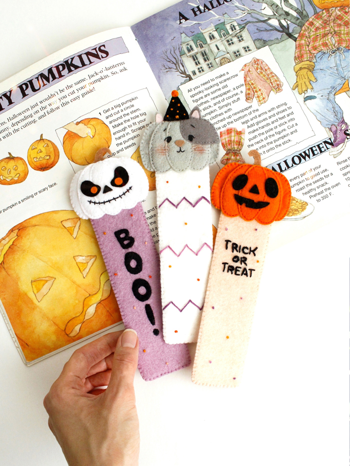 Three felt Halloween bookmarks displayed with printable sewing pattern